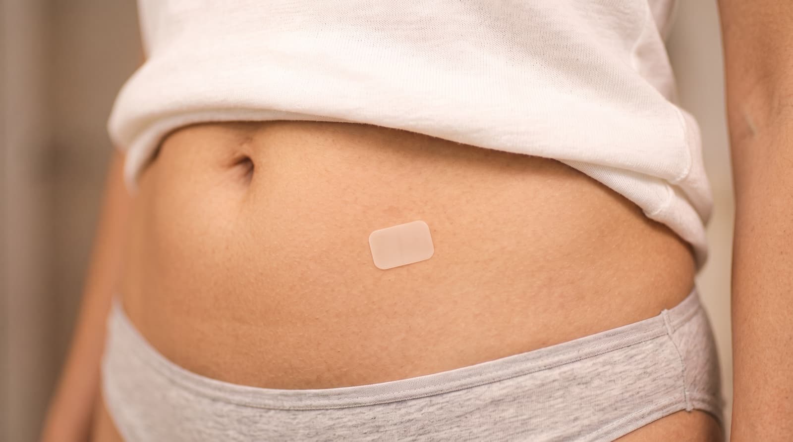 Hormone patch applied to a woman’s stomach